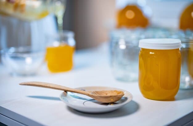 A bottle of fish oil supplement next to a measuring spoon on a kitchen counter, with a blurred image of a dog in the background. The focus is on the supplement and the correct dosage.