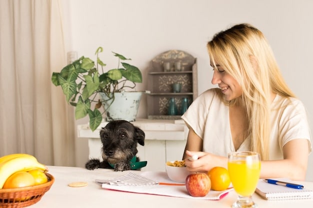 A vet is seen holding a bag of dog food, pointing to the ingredient list with a pen, while explaining something to a dog owner. Both are smiling.