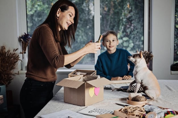 A woman crafting a simple puzzle toy for her dog using a cardboard box and some old towels. The woman is smiling, and the dog is watching attentively.