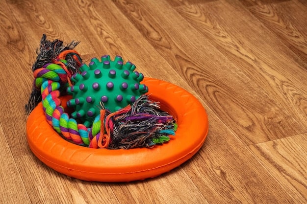 A collage showcasing various dog toys from different brands, including a KONG Classic, a Nylabone DuraChew, and a West Paw Zogoflex toy. The toys are arranged neatly on a neutral background.